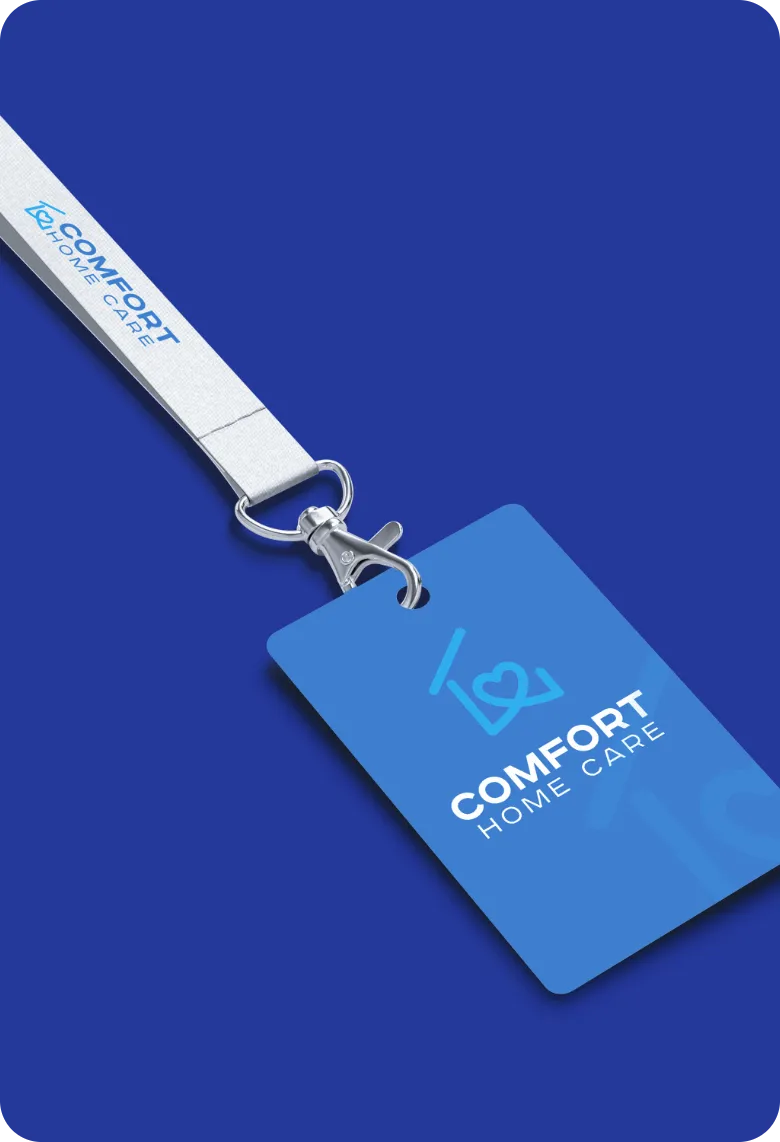 Comfort Home Care branded employee ID badge attached to a logo lanyard