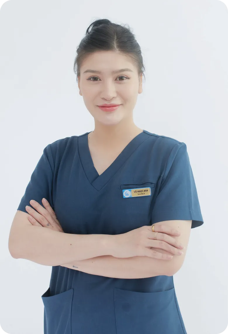 Professional female home caregiver in navy blue scrubs standing with arms crossed